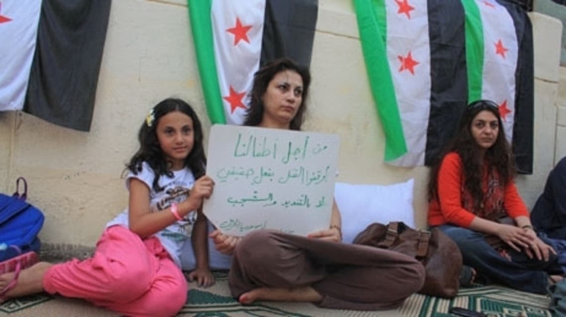 Demonstrators hunger-striking outside Arab League implore Egypt's authorities to improve conditions of Syrian refugees in Egypt. (AFP)