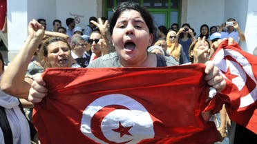 Belkaeis al-Brahimi, the daughter of Tunisian opposition politician Mohammad al-Brahimi, shouts outside a hospital after her father was killed on July 25, 2013. (AFP)