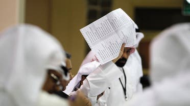 A judge counts votes during the early hours of the night after elections closed at the Khaldiya polling station in District 3, Kuwait City July 27, 2013.