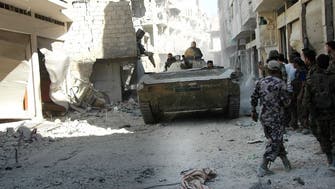 State TV: Syrian army retakes key Homs rebel district 