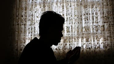Naser Gulzad, 25, prays in his Kabul home July 25, 2013. (Reuters)