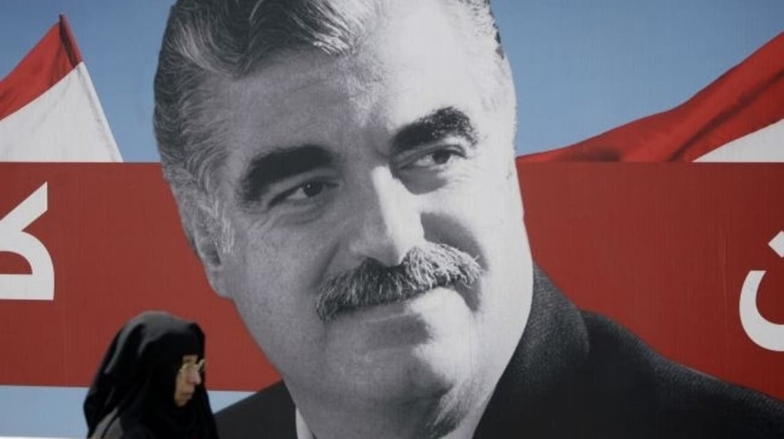 A Muslim woman walks past a portrait of slain Lebanese former premier Rafik Hariri displayed near his gravesite in central Beirut on August 19, 2011. AFP