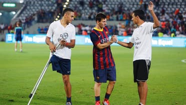 Barcelona's Lionel Messi (C) speaks with Mohammad Roman, a 17-year-old Palestinian from Jericho and Asael Shabo (L) a 19-year-old Israeli from the Jewish West Bank settlement of Kedumim, at the end of a soccer clinic with Arab and Jewish children at Bloomfield stadium in Tel Aviv August 4, 2013.