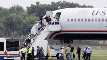 People exit a plane from Ireland that made an emergency landing because of an unspecified threat. (Courtesy Photo of AP)