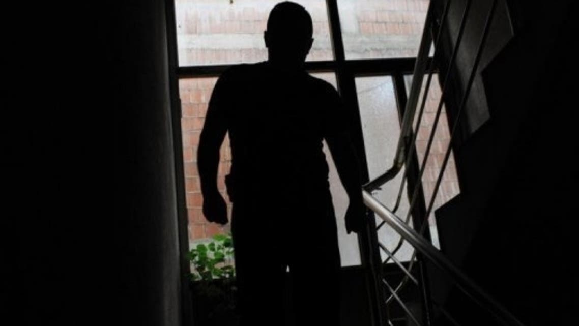 former Kosovo Liberation Army sniper who also fought with in Syria sits in his home near Pristina. (AFP)