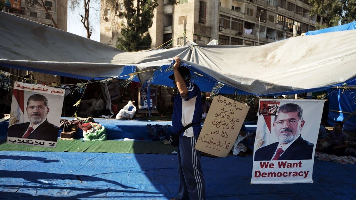 An Egyptian man fixes his tent as members of the Muslim brotherhood and supporters of ousted Egyptian President Mohammed Mursi attend a sit-in outside the Rabaa al-Adawiya mosque on August 10, 2013 in Cairo, Egypt. (AFP)