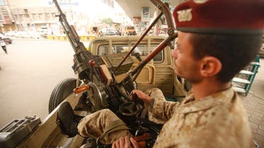 An army trooper sits beside a machinegun that is mounted on a patrol vehicle at at checkpoint in Sanaa August 5, 2013.