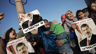 Egyptian women from the Muslim Brotherhood shout slogans and hold portraits of ousted President Mohammad Mursi as they gather in Cairo’s Galaa square to attend a march in his support on August 11, 2013.