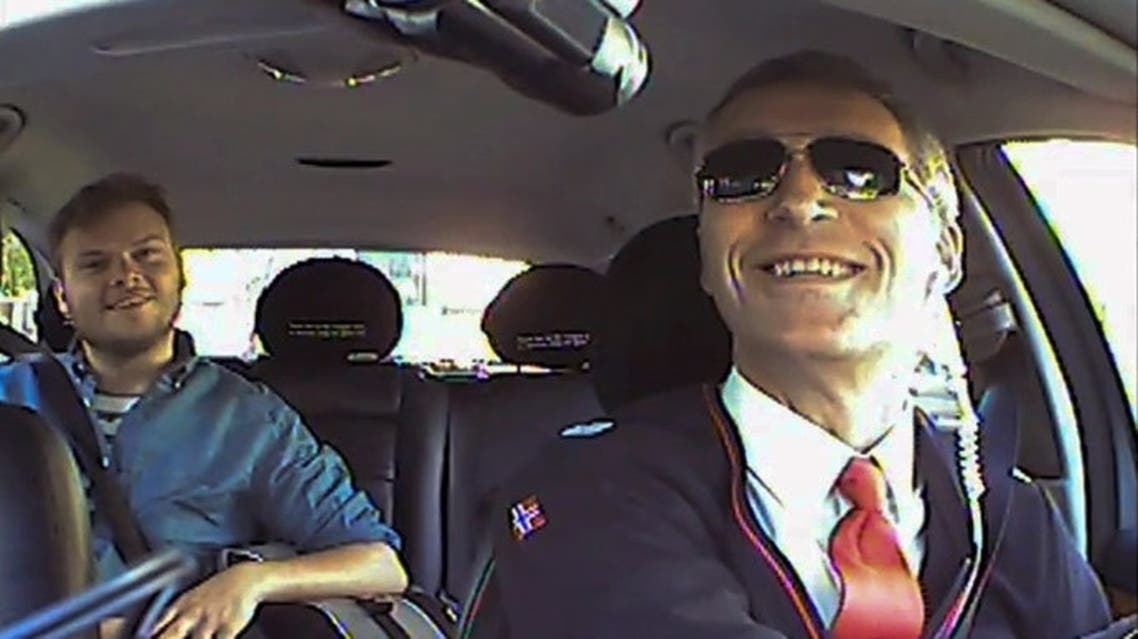 This undated low resolution video grab made available by the Norwegian Labour Party shows Norwegian Prime Minister Jens Stoltenberg (R) acting as a taxi driver in Oslo
