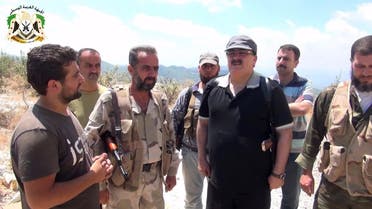 An image grab taken from a video published on the Youtube account Jableh1990 on August 11, 2013 allegedly shows Syrian rebel leader General Salim Idris (C-R) talking to rebel fighters in the outskirts of Latakia. (AFP)
