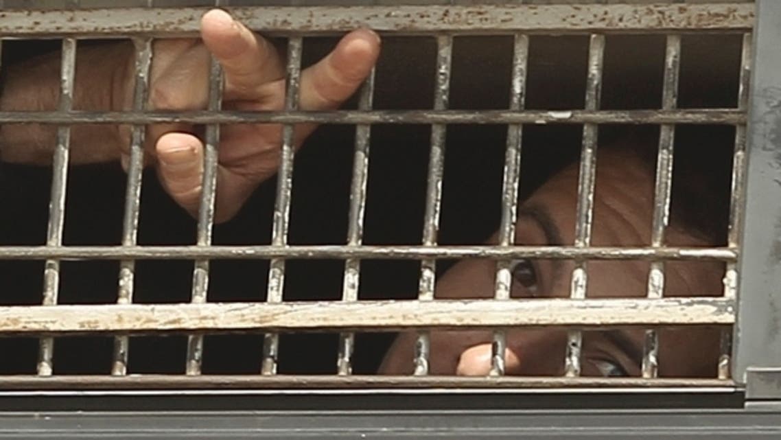 prison reuters A Palestinian prisoner gestures from the window of a bus as it leaves Nafha Prison near the southern Israeli town of Mitzpe Ramon, Oct. 16, 2011. (photo by REUTERS )