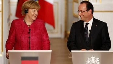 France's President Francois Hollande (R) and German Chancellor Angela Merkel attend a joint news conference at the Elysee Palace in Paris, May 30, 2013. (Reuters)