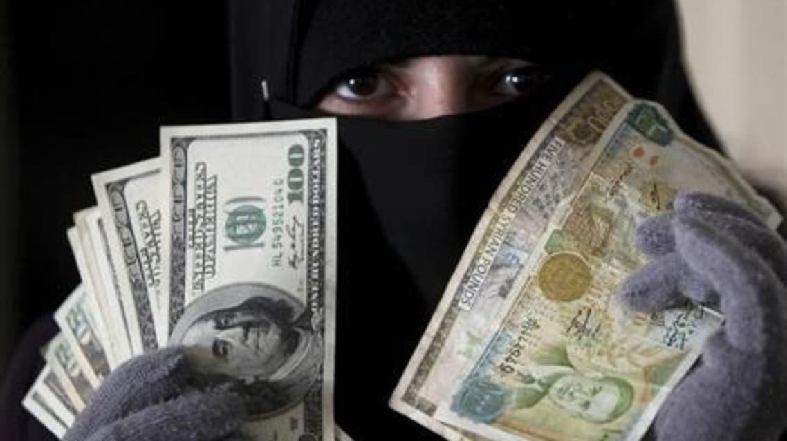 Dollars and currency in syria (File Photo: Reuters)