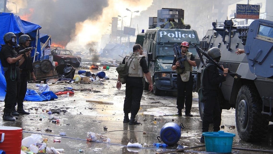 A media crew is seen next to riot police during clashes near Cairo on August 14, 2013. (Reuters)
