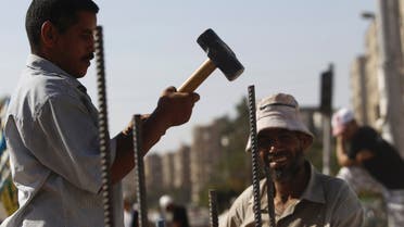 Muslim Brotherhood supporters build a wall with rebars and cement for protection against any attack, at the entrance to their camp at Rabaa Adawiya Square, east of Cairo August 11, 2013. (Reuters)