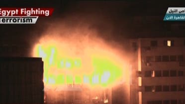 Fire consumes the Arab Contractor’s building at Ramses Square in Cairo. (Al Arabiya)