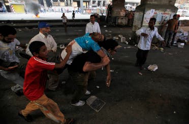 Supporters of deposed Egyptian President Mohamed Mursi carry an injured demonstrator who was shot during clashes in front Azbkya police station at Ramses Square in Cairo, August 16, 2013. (AFP)