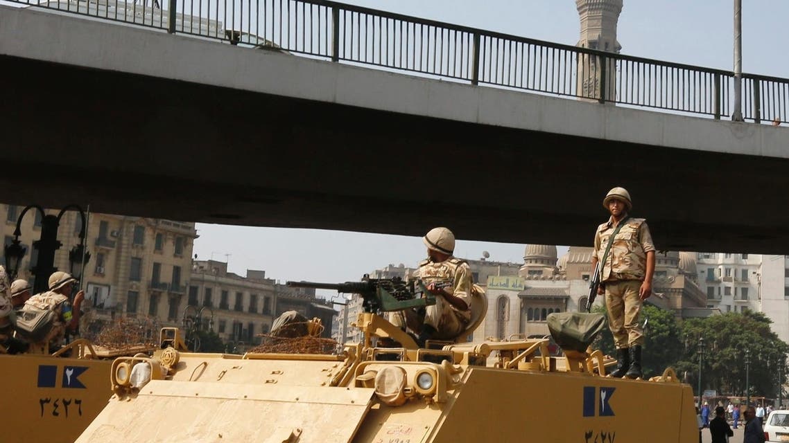 A soldier holds his weapon as he stands on an armoured personnel carrier positioned outside Ramses Square, near al-Fath mosque in Cairo August 17, 2013. (Reuters)