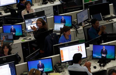 Journalists applaud in the newsroom as Al Jazeera America begins broadcasting in New York, August 20, 2013. (Reuters)
