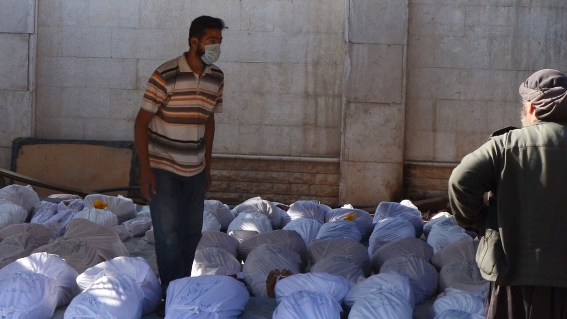 Syrian activists inspect the bodies of people they say were killed by nerve gas in the Ghouta region. (Reuters)