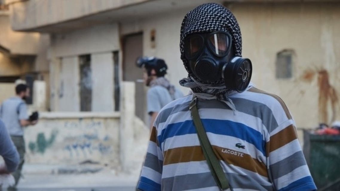 An activist wearing a gas mask is seen in the Zamalka area, where activists say chemical weapons were used by forces loyal to President Bashar Al-Assad in the eastern suburbs of Damascus August 22, 2013. (Reuters)