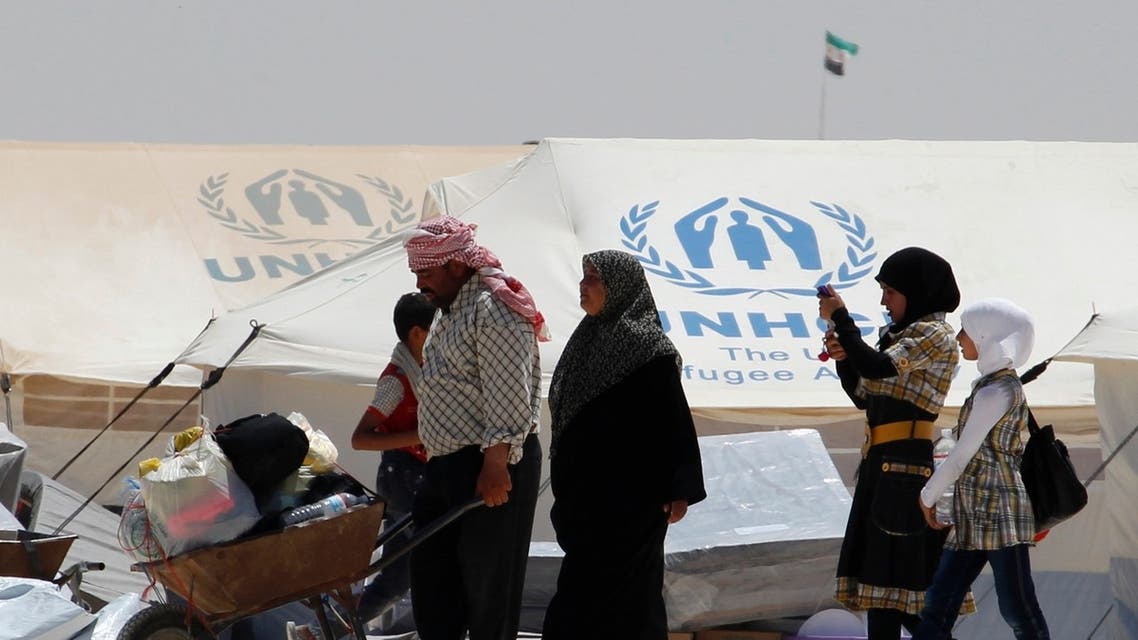 A newly arrived Syrian refugee receives aid and rations, at Al-Zaatri refugee camp in the Jordanian city of Mafraq, near the border with Syria, on World Refugee Day, June 20, 2013. Reu
