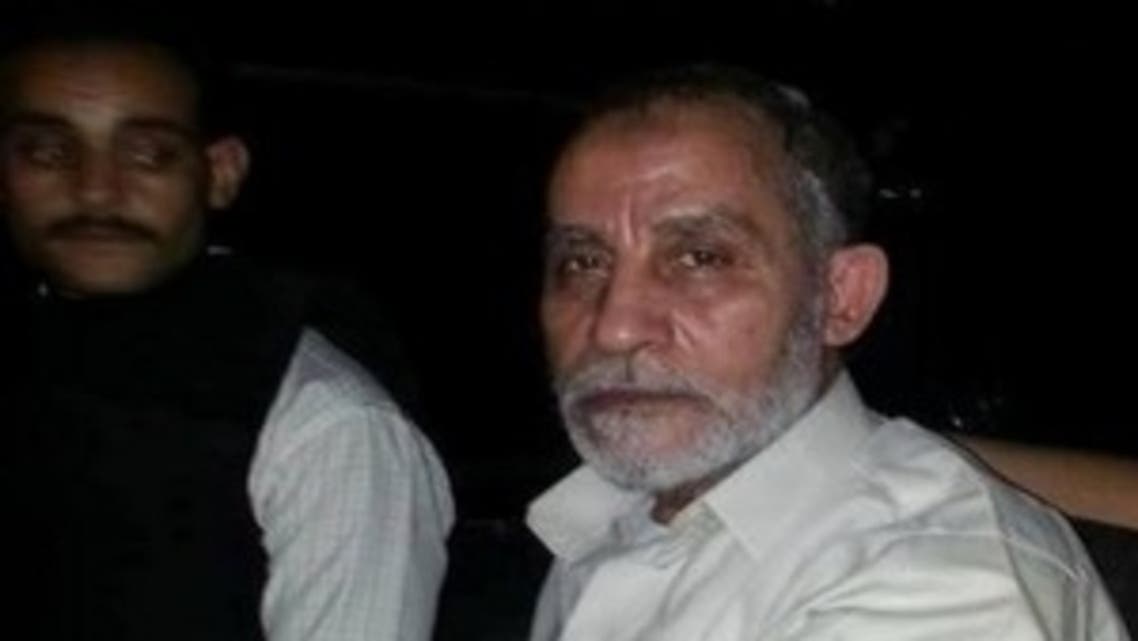 Muslim Brotherhood leader Mohamed Badie (R) sits in a police vehicle after being arrested by security forces in Cairo (File Photo: Reuters)