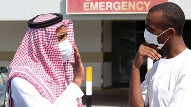 Men outside a hospital in Dammam, Saudi Arabia, wear surgical masks as a precaution against infection. (File Photo: Reuters)