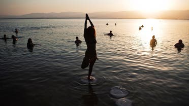 A woman practices yoga during a mass floating event in the Dead Sea. (File Photo: Reuters)