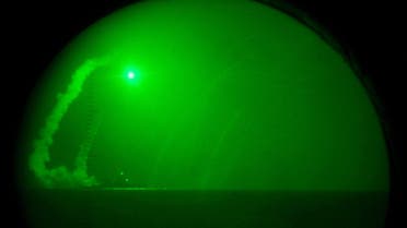 The guided missile destroyer USS Barry fires Tomahawk cruise missiles in support of Operation Odyssey Dawn as seen through night vision goggles in the Mediterranean Sea March 19, 2011. reuters
