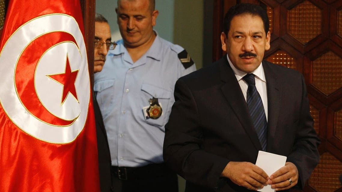 Tunisia’s Interior Minister Lotfi Ben Jeddou (R) arrives for a news conference in Tunis Aug. 28, 2013. (AFP)