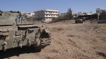 Free Syrian Army (FSA) fighters are seen at a tank that belonged to forces loyal to Syria's President Bashar al-Assad after the FSA said they fought and defeated government troops in the town of Basr al-Harir in the southern province of Deraa in this August 27, 2013 Reuters
