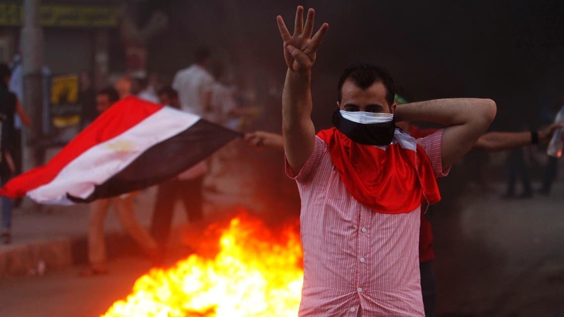A supporter of ousted Egyptian President Mohamed Mursi makes the "Rabaa" or "Four" gesture during clashes at Mohandiseen in Cairo August 30, 2013.