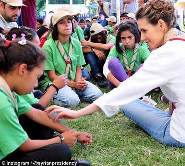 British-born Asma al-Assad reaches out to an unhappy young girl on August 11. (Photo courtesy: Instagram)