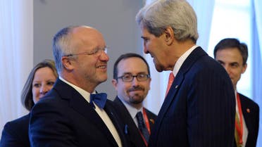 U.S. Secretary of State John Kerry (R) is greeted by Lithuanian Minister of National Defense Juozas Olekas at the Presidential Palace in Vilnius September 7, 2013. (Reuters)