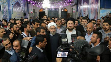 Iranian President-elect Hassan Rohani (C) speaks to the media following a visit to the Khomeini mausoleum in Tehran June 16, 2013. 