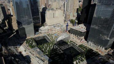 In this photo taken Thursday, Sept. 5, 2013, the wedge-shaped pavilion entrance of the National September 11 Museum, center, is located between the square outlines of the memorial waterfalls at the World Trade Center in New York. 