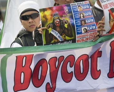 A Muslim protester holds a poster during an anti-Miss World protest in Jakarta on September 6, 2013. (AFP)