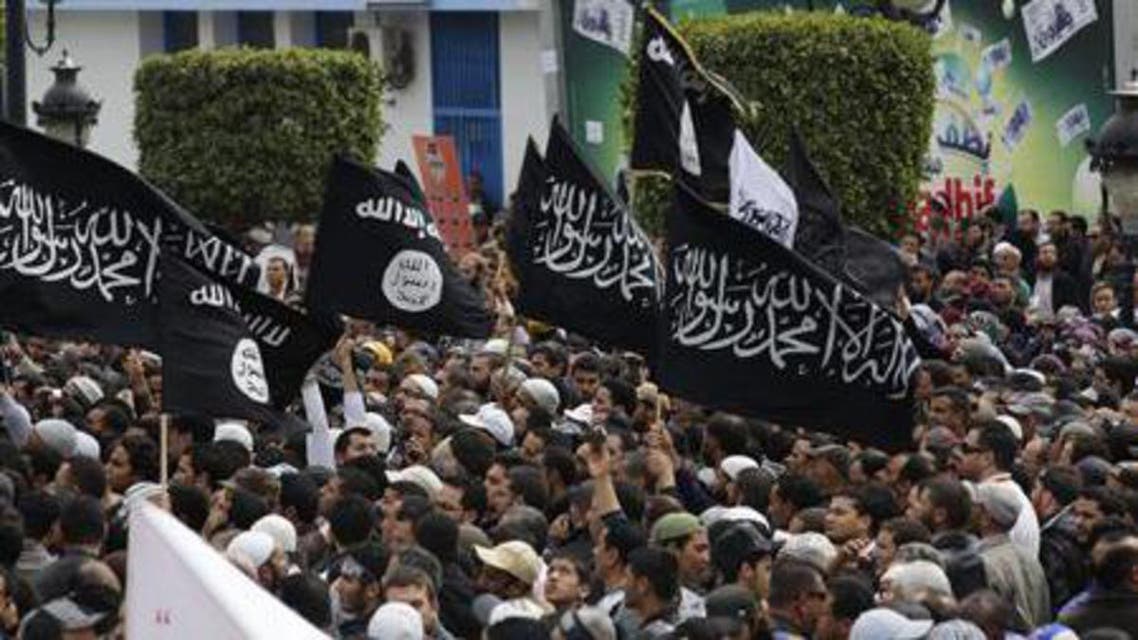 Demonstrators hold flags during a protest demanding the inclusion of Islamic Law in the constitution, in Tunis March 25, 2012. (Reuters)