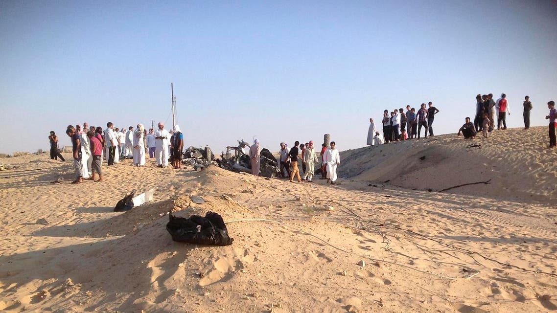 People check the scene where a car bomb exploded in near the port town of El-Arish in Egypt's Sinai peninsula July 24, 2013. reuters