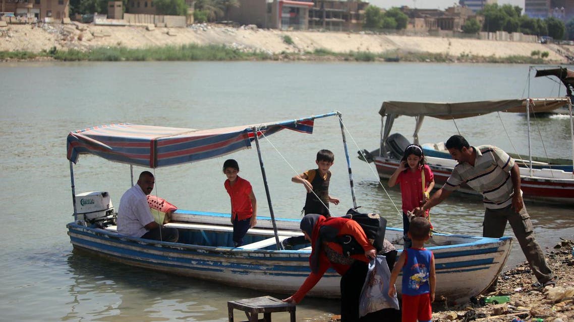 Boat owners wait for customers along the Tigris River which flows through the Iraqi capital of Baghdad on September 11, 2013. (AFP)