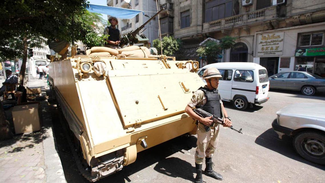 A soldier stands next to an armored personnel carrier (APC) near the al-Fath mosque on Ramses Square in Cairo, September 11, 2013. (Reuters)