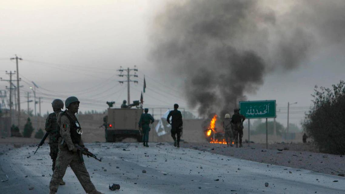 Afghan soldiers walk towards flames outside the U.S. Consulate after an attack by insurgents, in Herat province September 13, 2013. (Reuters)