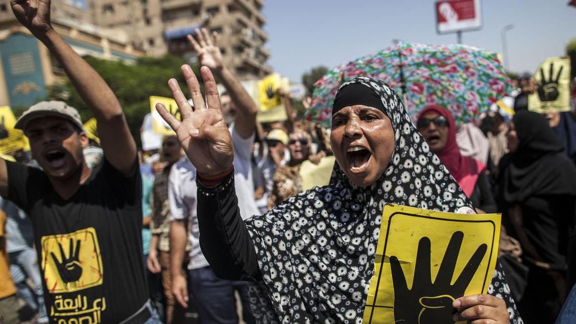Supporters of ousted Egyptian president Mohamed Morsi raise up posters with the four finger symbol during a demonstration against the military backed government in the Egyptian capital Cairo, on September 13, 2013. afp