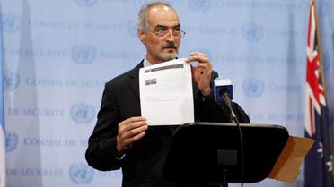 Syrian U.N. Ambassador Bashar Ja'afari shows a document to reporters at the United Nations Headquarters in New York, September 12, 2013.  (Reuters)