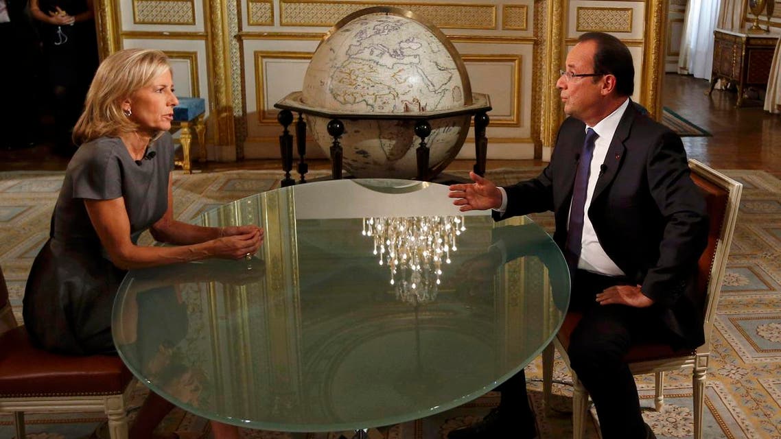 France's President Francois Hollande (R) takes part in a televised interview with French journalist Claire Chazal on French TF1 television channel's prime-time evening news broadcast in Paris, September 15, 2013. reuters