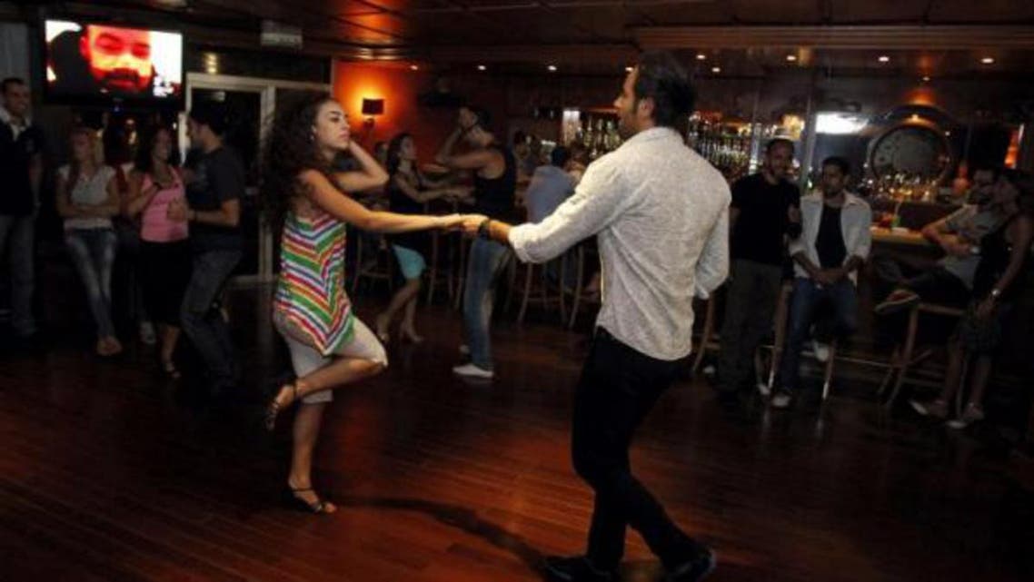 Syrians dance in a night club in the capital Damascus on September 14, 2013. AFP
