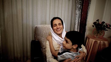 Iranian lawyer Nasrin Sotoudeh hugs get son Nima at her home in Tehran on Sept. 18, 2013, after being freed after three years in prison. (AFP)