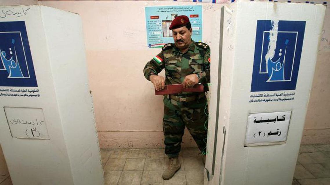 A member of a Kurdish Peshmerga battalion leaves the voting booth before casting his ballot during the region's legislative elections at a polling station on September 19, 2013 in the northern Kurdish city of Arbil.