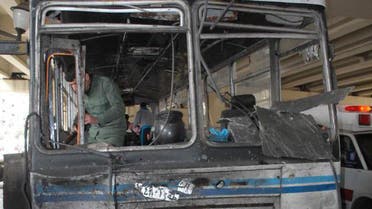 A file photo shows a damaged bus at the site of a bomb attack in the Midan neighborhood in the heart of  Damascus earlier in 2012.  (AFP) 